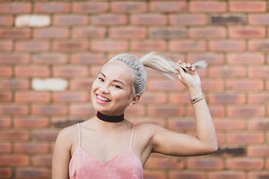 Young adult female posing for photo on street