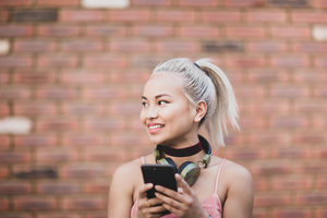 Young adult female messaging on smarphone