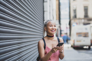 Young adult female messaging on smarphone