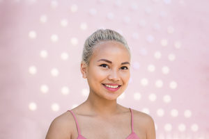 Young adult female with pink background