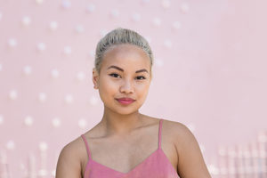 Portrait of young adult female with pink background