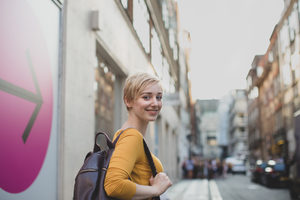 Young adult female walking down street