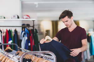 Young adult male clothes shopping