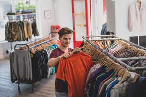 Young adult male clothes shopping