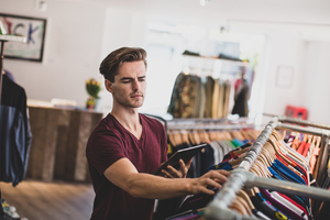 Store manager checking stock in a clothing store