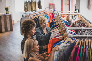 Millennial female friends shopping in a vintage clothing store