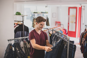 Young adult male clothes shopping