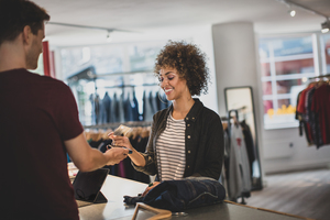 Customer paying for clothes at checkout