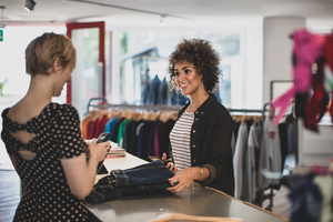 Customer paying for clothes at checkout