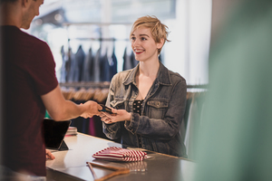 Customer paying for clothes at checkout