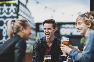 Friends drinking in an outdoor bar in summer