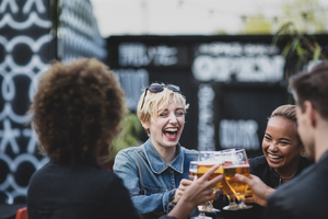 Friends drinking in an outdoor bar in summer