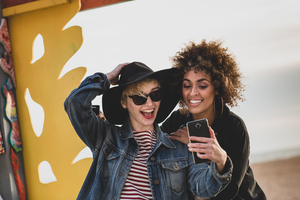Friends taking selfie on windy beach