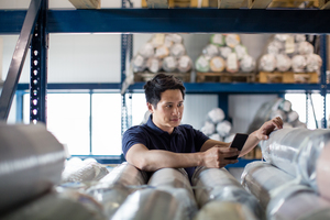 Male scanning item in distribution warehouse