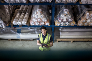 Male working in distribution warehouse with digital tablet