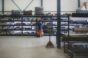 Male working in warehouse using forklift truck