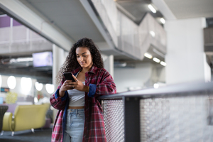 Female student looking at smartphone in high school