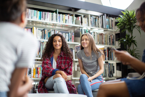 High school students studying together in a library