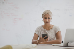 Portrait of Muslim businesswoman using a smartphone
