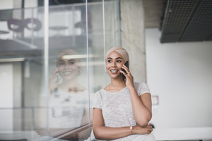 Muslim businesswoman using a smartphone in an office