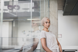 Reflection of Muslim businesswoman in an office
