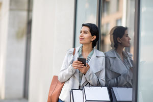 Arabic woman using a smartphone on a shopping trip