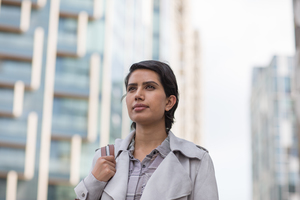 Arabic businesswoman walking through modern city