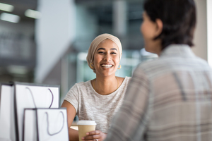 Female Muslim friends having coffee together in a shopping mall