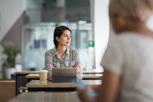 Arabic businesswoman looking out of the window of a cafe