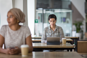 Arabic businesswoman using a digital tablet in a cafe
