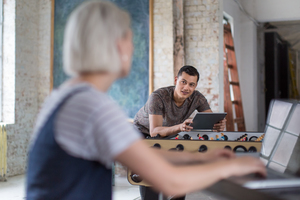 Young adult male using digital tablet in a creative office