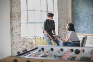 Young adults in a meeting in a creative studio with a digital tablet