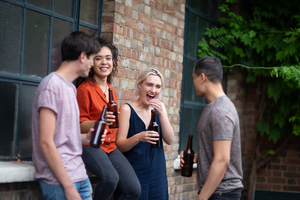 Millennials drinking beer in pub garden