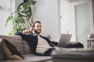 Adult male working from home in living room