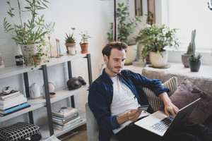 Adult male using credit card online