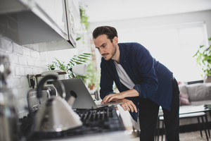 Adult male working from home in kitchen
