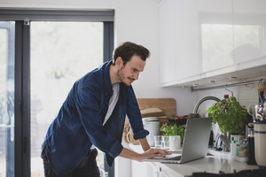 Adult male working from home in kitchen