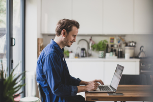 Adult male working from home in kitchen