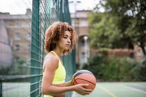 Young adult female on a basketball court