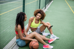 Friends taking a break from training on a basketball court
