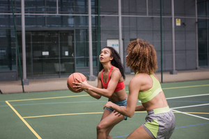 Young adult female basketball player about to shoot a hoop 