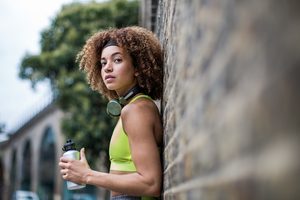 Young adult female taking a break on a run