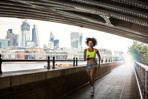 Young adult female running in city of London