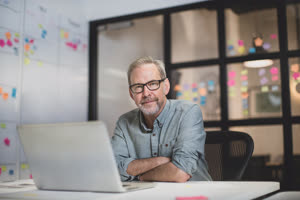 Portrait mature male working late in an office