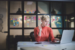 Young adult female working late in an office