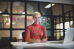 Portrait young adult female working late in an office