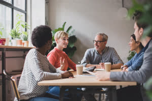 Group of coworkers having a meeting in a cafe