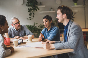 Group of coworkers having a meeting in a cafe