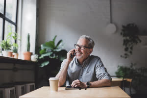 Mature businessman working in a cafe