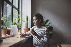 Freelance african american businesswoman working in a cafe